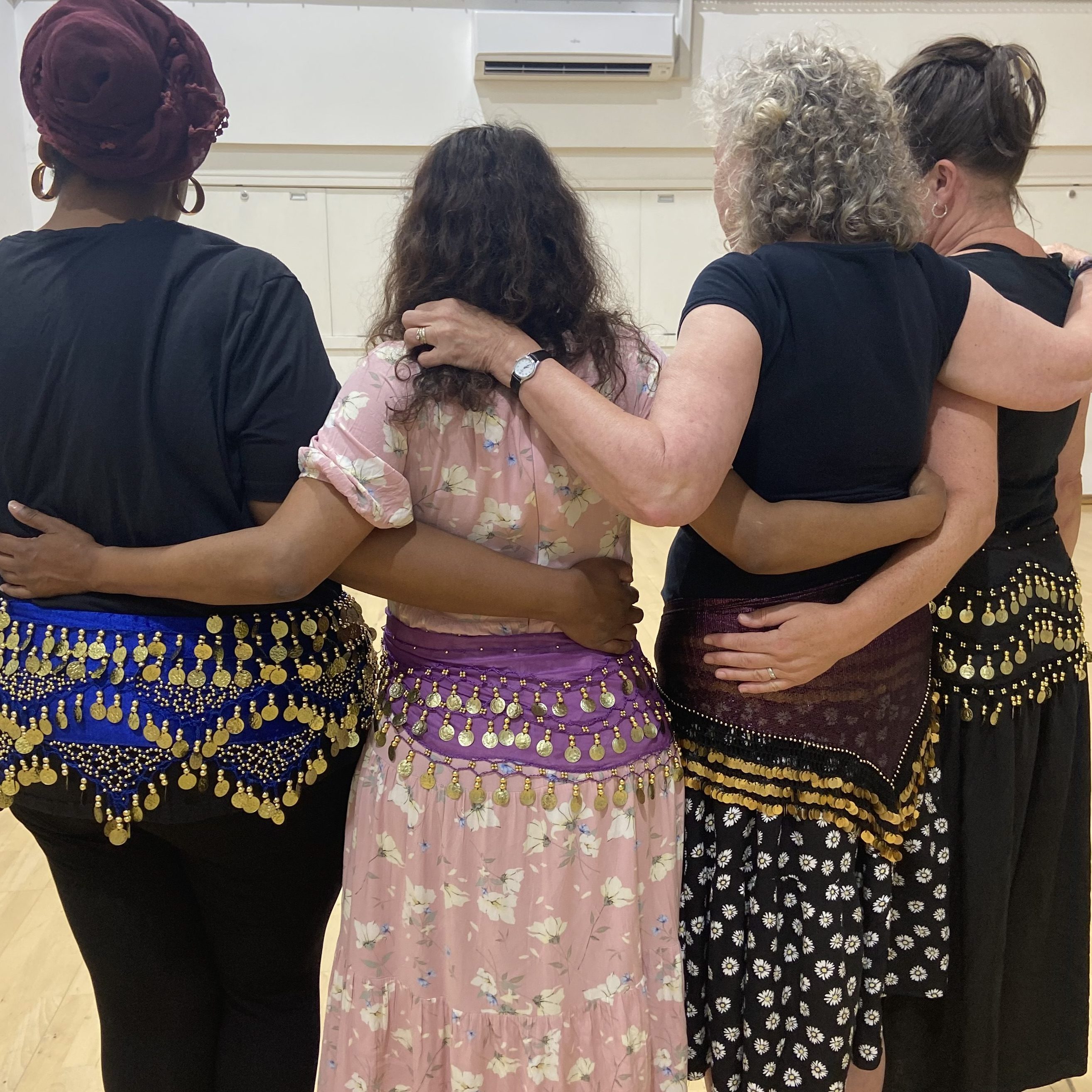 Epsom bellydance student community with arms around each other